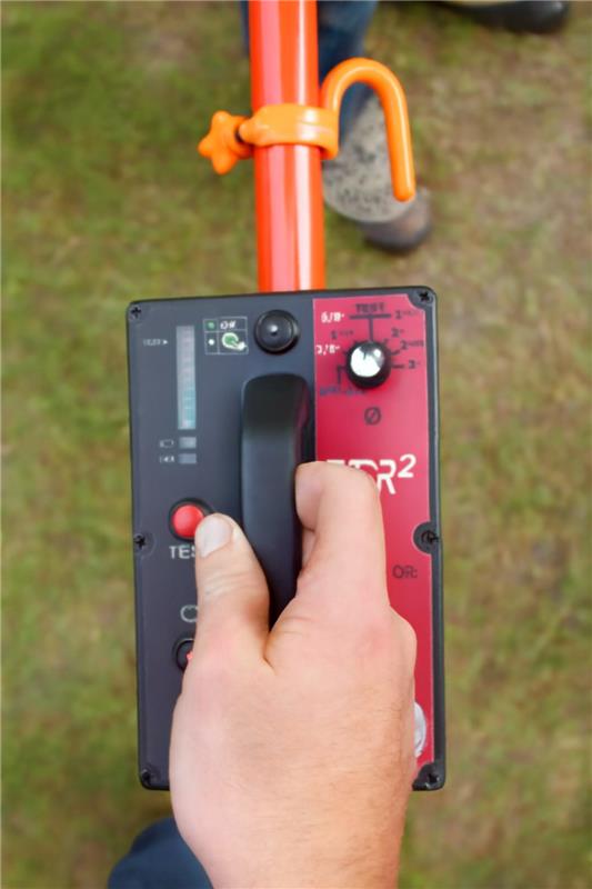 Foam cored insulated hot stick control panel with hand gripping the handle, designed for field inspections.