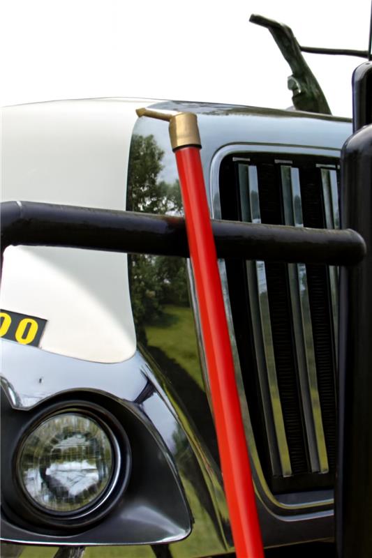 Insulating switch stick with foam core, 1.25-inch diameter, positioned near a truck's front grille for utility work.