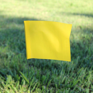 Yellow marking flag on a stake, ideal for utility, landscaping, and surveying applications. Solid and custom options available.