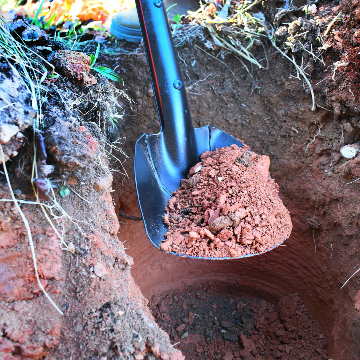 TiiGER Eastern Spoon cleaning out a utility pole hole on the jobsite