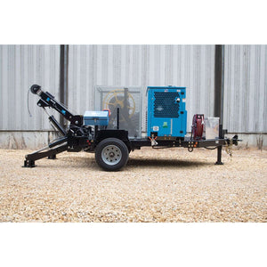 Blue Ox cable puller with compressor and outriggers deployed at a utility jobsite