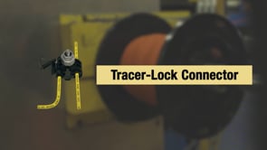 Tracer-Lock Connector with yellow wire leads on a workshop background, designed for direct-burial wire connections.